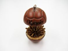 A French painted chrome cigarette dispenser modelled as a brown leather football
titled OLYMPIA,