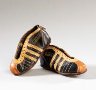 A miniature pair of early Adidas football boots thought to be salesman`s samples during the