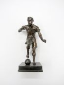 A spelter footballer, modelled with the ball at his right foot, 28cm., 11in. Provenance: Torino