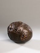 A bronze sculpture of rugby ball, signed by the sculptor with the initials J.W., stylised artist`s