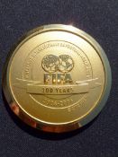 An official medal struck to commemorate the centenary of FIFA 1904-2004, in gilt, inscribed obverse