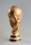 A gilt-painted full size replica of the FIFA World Cup trophy, 36cm., 14in.