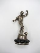 A trophy cup cover surmounted with a figure of a footballer, 15cm., 6in Provenance: Torino Olympic