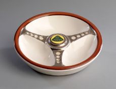 Lotus steering wheel novelty ceramic ashtray, bearing the green on yellow Lotus car company emblem