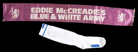 A Dave Webb signed white Chelsea sock, by Umbro; sold together with a Chelsea supporter`s scarf