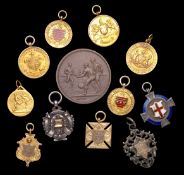 A group of twelve Edwardian football medals awarded to Harold A. (""Toby"") Milton, comprising: i)