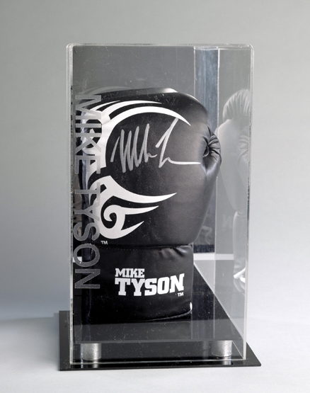A signed Mike Tyson branded boxing glove in a custom made display case,
black, signed in silver