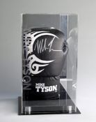 A signed Mike Tyson branded boxing glove in a custom made display case,
black, signed in silver