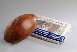 A leather vintage-style rugby ball signed by the England 2003 Rugby World Cup winning captain Martin