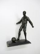 A spelter footballer,
modelled with the ball at his feet, 25.5cm., 10in.

Provenance: Torino Olympic