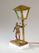 A table lamp designed with a brass footballer set on a marble base,
the lamp post with detachable