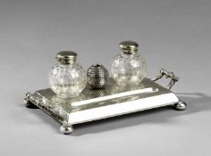 A golfing ink stand circa 1910,
in electroplate with two glass ink pots with markings of a mesh