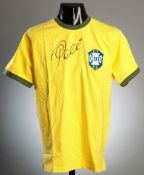 A yellow replica Brazil 1970 World Cup jersey signed by Pele,
signature in black marker pen