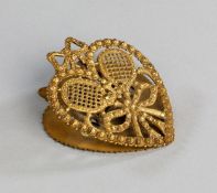 A Victorian brass paper clip,
heart-shaped openwork design with crossed lawn tennis racquets