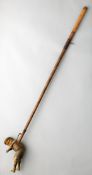 A Schoenut wooden indoor golf game figure circa 1920,
wooden golfer attached to a shaft, lever