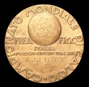 A 1934 World Cup bronze medal,
designed by G. Manetti, obverse with three footballers in raised