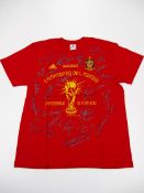 A commemorative red t-shirt signed by the Spanish FIFA 2010 World Cup winning team,
signatures in