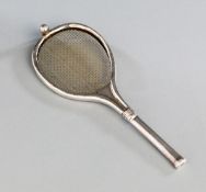 A silver tea strainer designed as a tennis racquet,
hallmarked Birmingham, 1907, with tennis ball