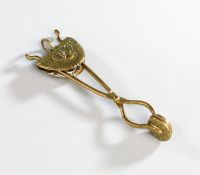 A ladies lawn tennis skirt lifter,
brass with peacock design