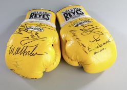 A pair of multi-signed boxing gloves,
Reyes, the left glove signed by Lennox Lewis, Prince Nazeem