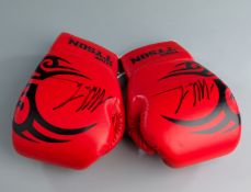 A pair of signed Mike Tyson branded boxing gloves,
red, both signed in black marker pen