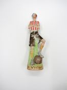 A china figurine of a bruised & battered footballer titled 'The Victor',
19cm., 7 1/2in.
