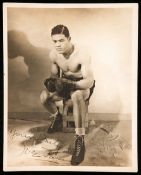 A fine quality Joe Louis signed photograph,
a 9 by 7in. b&w period photograph, signed in fountain