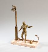 A pocket watch stand designed with a footballer set on a marble plinth,
with a lamppost design for