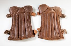 A pair of vintage leather football shin pads