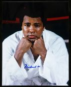 A Muhammad Ali signed 10 by 8in. photograph,
pictured in a robe sweating after a training session