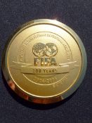 An official medal struck to commemorate the centenary of FIFA 1904-2004,
in gilt, inscribed