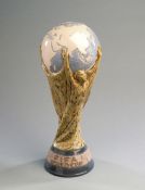 A Lladro porcelain model of the World Cup trophy,
inscribed FIFA WORLD CUP, the base inscribed