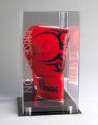 A signed Mike Tyson branded boxing glove in a custom made display case,
red, signed in black