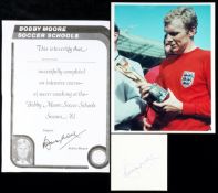 A Bobby Moore autograph,
signed in blue ink on a square of stiff paper; sold together with a