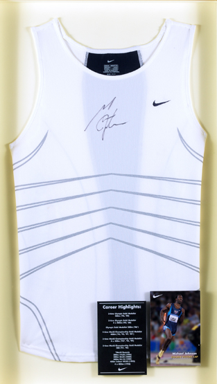 A Michael Johnson signed athletics vest,
signature in black marker pen, mounted in a frame under