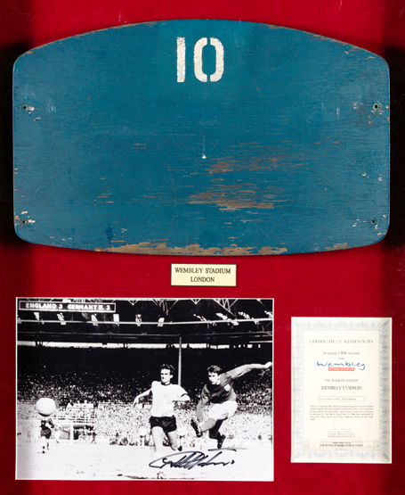 A wooden No.10 seat back from the old Wembley Stadium mounted together with a signed b&w