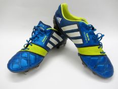 Nigel de Jong: a pair of blue & yellow Adidas Isaura 34 Nitrocharge 1.0 football boots 2013,