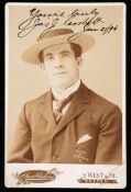 A sepia-toned photographic cabinet card portrait of the Irish-American Heavyweight Boxing Champion