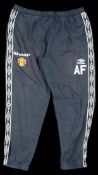 A pair of Sir Alex Ferguson Manchester United track suit bottoms,
by Umbro, blue with Sharp