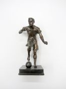 A spelter footballer,
modelled with the ball at his right foot, 28cm., 11in.

Provenance: Torino