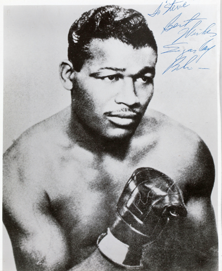 A signed Sugar Ray Robinson b&w picture,
9 by 7in., signed in blue biro with personalisation from