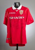 A Manchester United replica 1999 Champions League Final jersey signed by 17 squad members,