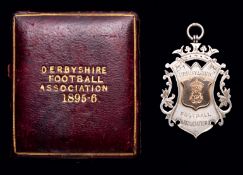 A gold-mounted silver Derbyshire F.A. Minor Cup medal 1895-96,
in original case of issue