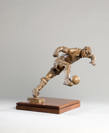 A Frederick Kail metalware figure of a footballer,
signed by the American sculptor in gold pen to