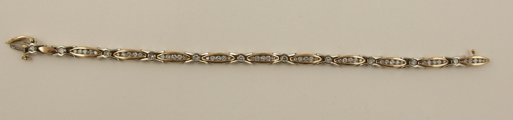 A 9ct diamond set line bracelet set throughout with illusion set diamonds to the marquis and cross