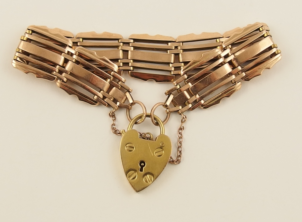 An Edwardian 9ct rose gold gate bracelet with unusual decorative links, with 9ct yellow gold heart