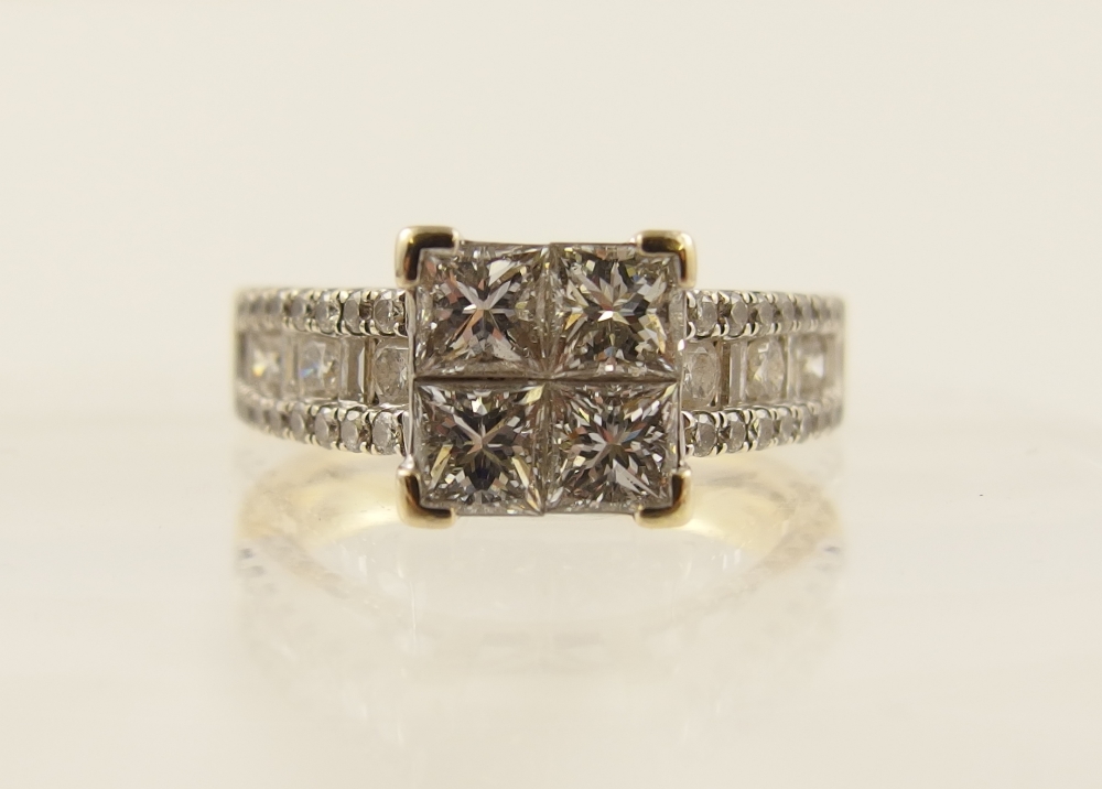 An 18ct princess cut diamond ring the central panel of four princess cut diamonds, with further