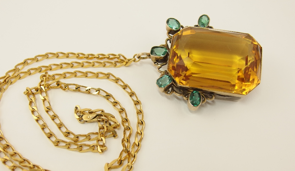 An impressive citrine pendant set in yellow and white metal the large scissor cut octagonal citrine
