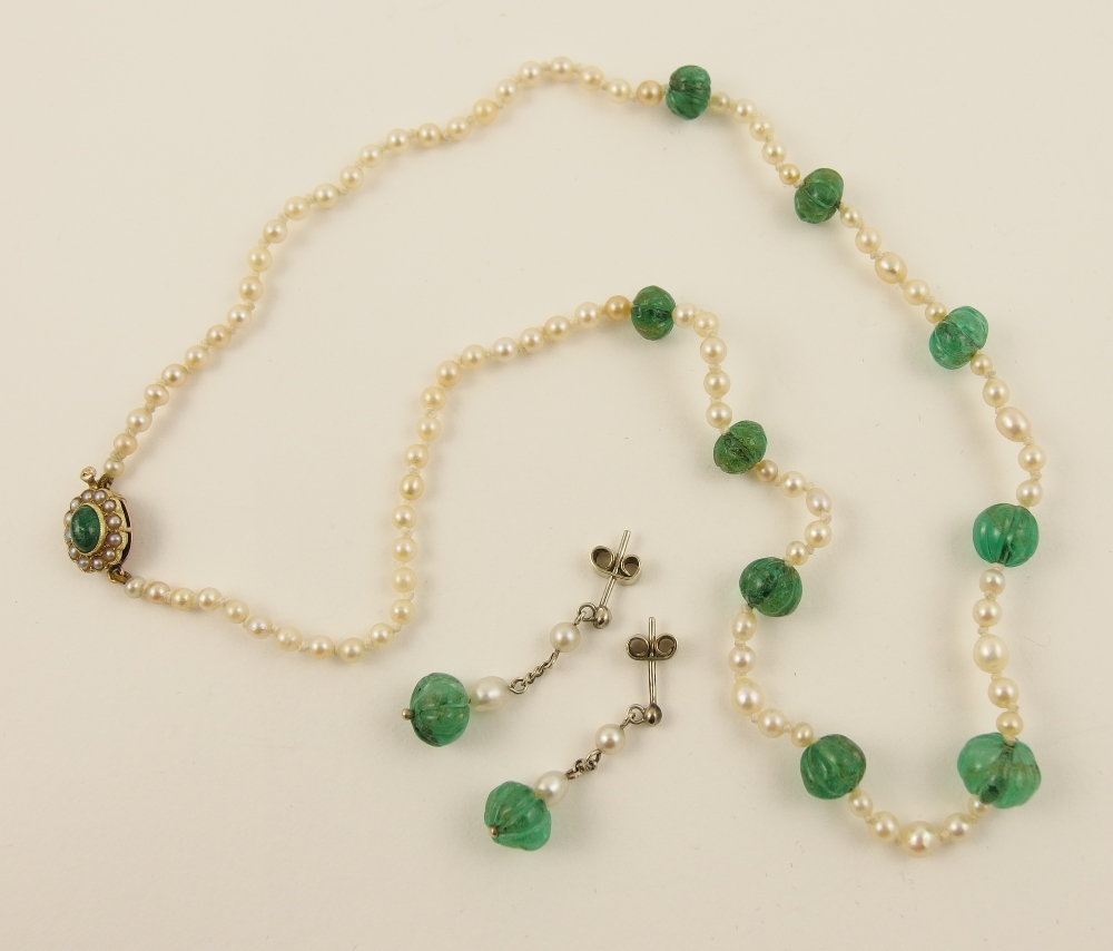 A string of pearls with carved emerald beads the pearls of slightly baroque shape possibly
