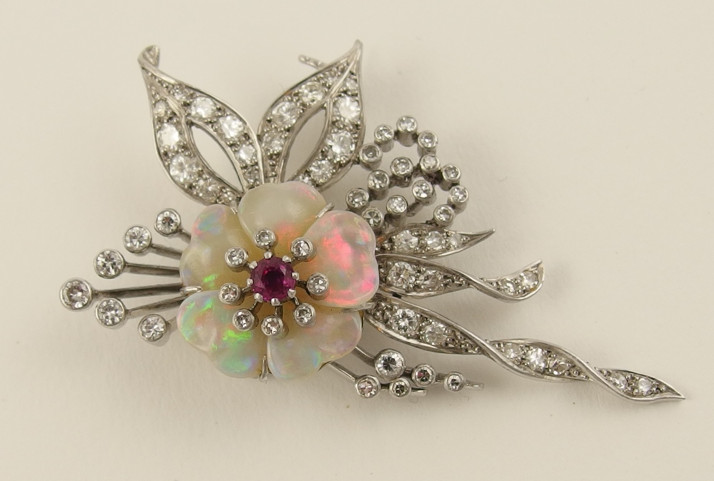 A diamond and opal flower brooch in platinum and 18ct white gold the floral spray set with rub over